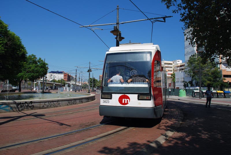 An electric tram rounds the loop at Pont de Fusta in Valencia, Spain on September 4, 2019. Part of the Metrovalencia network, it is one of three tram lines in the City. An electric tram rounds the loop at Pont de Fusta in Valencia, Spain on September 4, 2019. Part of the Metrovalencia network, it is one of three tram lines in the City.