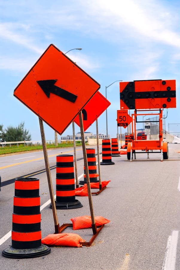 Road construction signs and cones on a city street. Road construction signs and cones on a city street