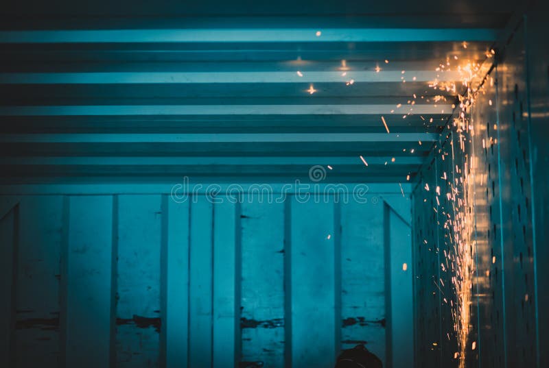 A stream of bright sparks inside a metal container stock images