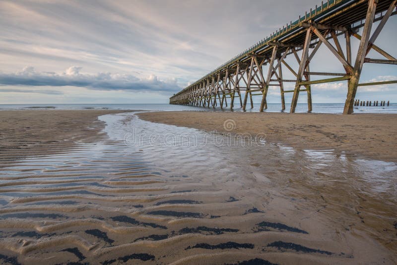 Small Stream on a Sandy Beach with an Old Pier. Hdr bridge stock images, royalty-free photos and pictures