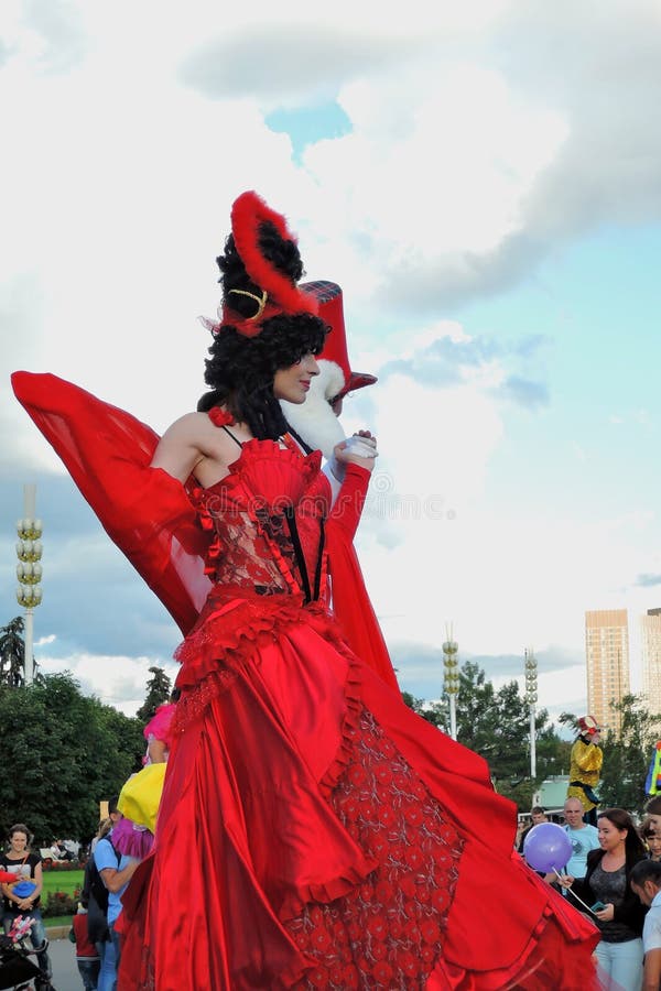 Street actor woman poses for photos in red dress stock photo Street actor woman poses for photos in red dress stock photo