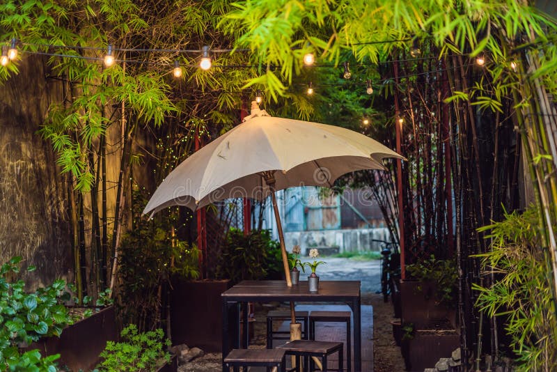 A Street Cafe with an Umbrella and Lights Stock Image Image of object