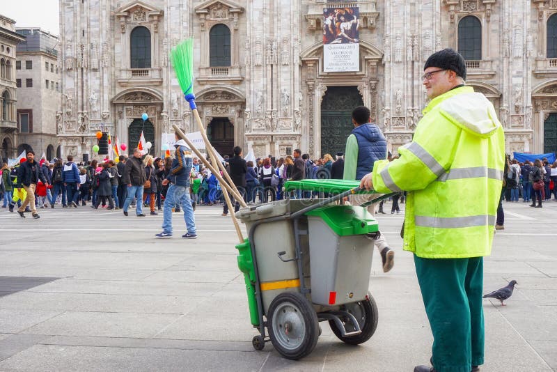 Street cleaner looking people joining Andem al Domm parade in Milan Italy stock photos Street cleaner looking people joining Andem al Domm parade in Milan Italy stock photos