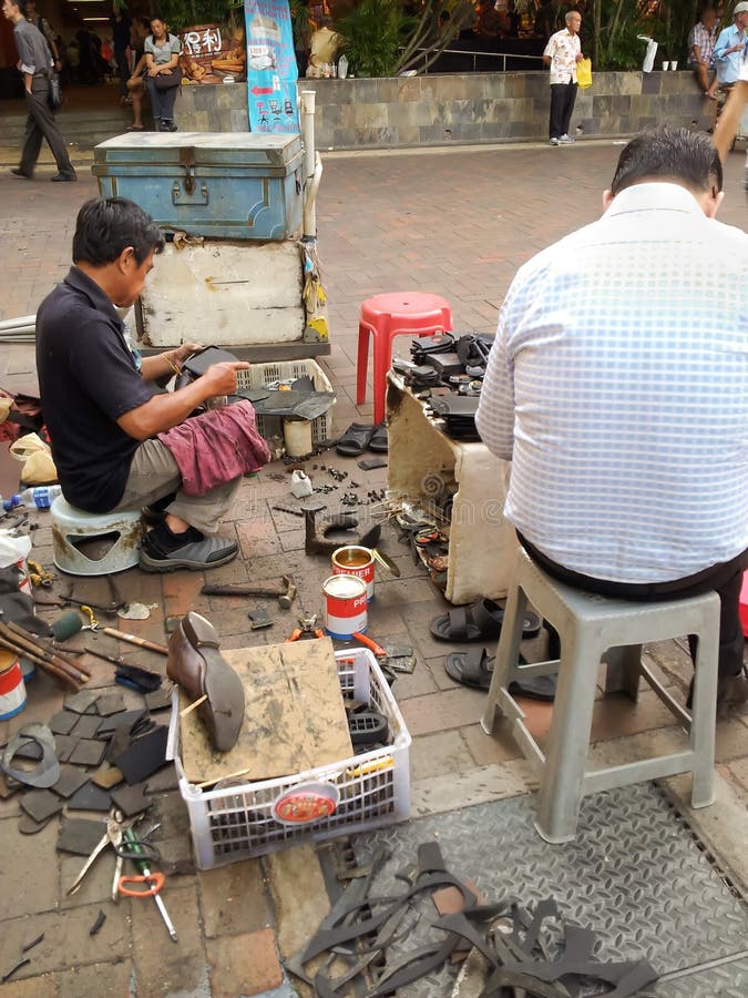 Cobbler Repairs Shoes in Walled City Lahore, Pakistan Editorial