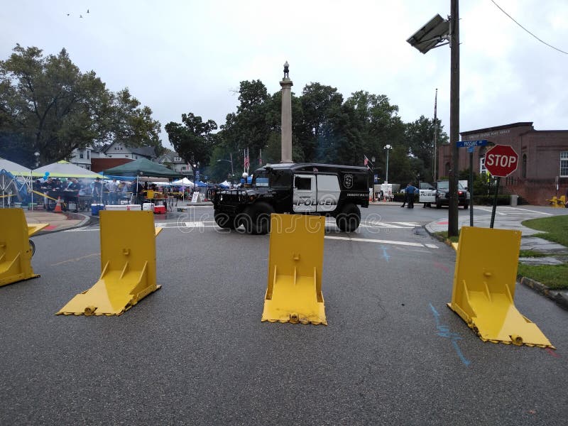 Mobile barriers were deployed to protect attendees of 44th annual Labor Day Street Fair.
This photo was taken in Rutherford, New Jersey, on September 2nd 2019. street fair blockade, yellow meridian barriers protecting people, rutherford, nj, usa, fairthis, hummer, dept, department, fund, funding, federal, police, law, enforcement, bright, hostile, vehicle, vehicles, mitigation, fairs, festival, festivals, stop, stopping, terrorist, terrorists, terrorism, anti, fight, against, portable, barricade, barricades, downtown, circle, traffic, blocking, suburban, suburbs, , safety, public, security, high, homeland, ram, ramming, device, crash, protection, technology, tactical, steel