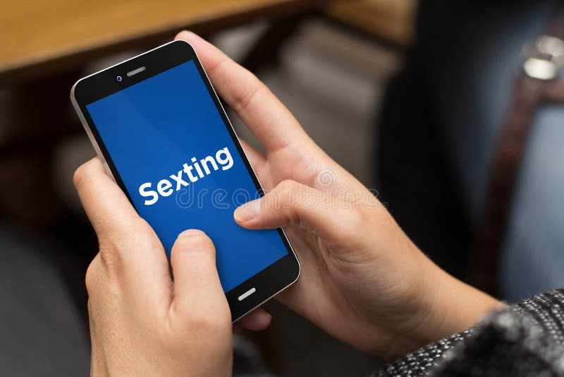 Connectivity and security concept: girl using a digital generated phone with sexting on the screen. All screen graphics are made up. Connectivity and security concept: girl using a digital generated phone with sexting on the screen. All screen graphics are made up.