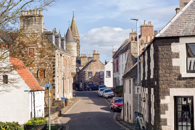 Street in the historic village of Falkland in Scotland, home of Falkland Palace. Cars parked along the road