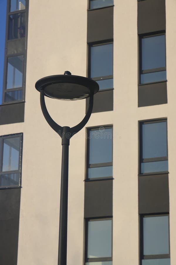 Street lamp against the backdrop of the facade of a modern building, urbanism, 2 stock photography
