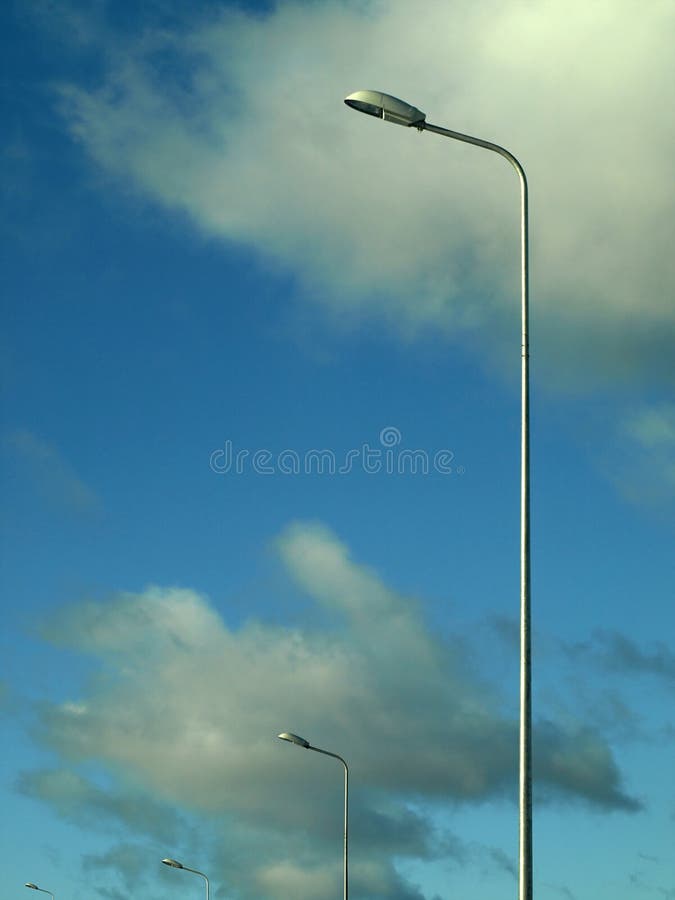 Street lamps over cloudy background