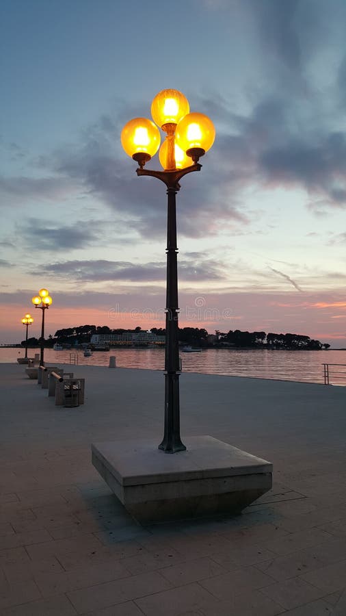 Street lamps at sunset stock photo. Image of pole, calm - 99980114