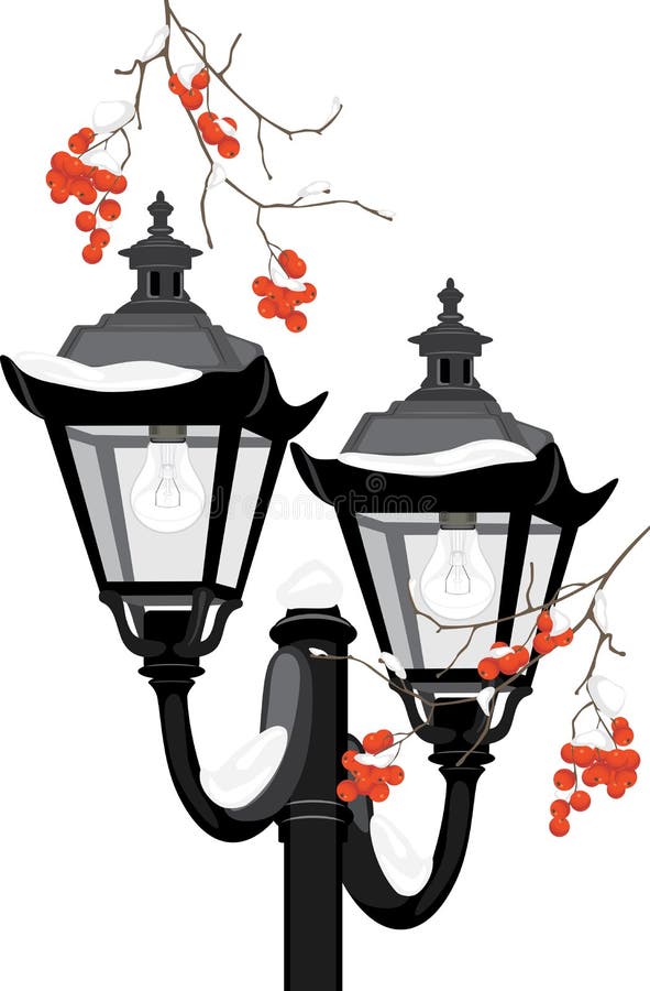 Street lantern among snowy rowan branches