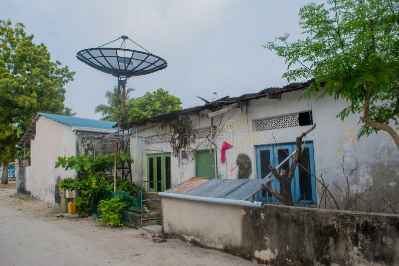 Street with old house and trees at the tropical island Fenfushi