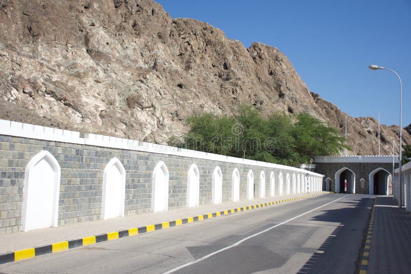 The street into Old Town Muscat, Oman with gates and tunnel in and through the mountains. royalty free stock photos The street into Old Town Muscat, Oman with gates and tunnel in and through the mountains. royalty free stock photos