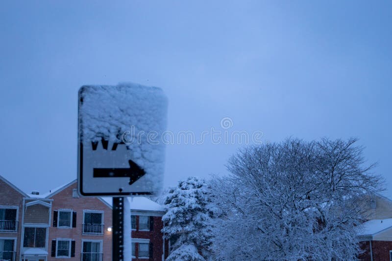 The Street Sign is Covered with Snow Outside in the Cold Stock Image