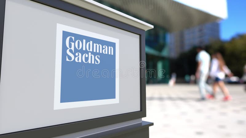 Street signage board with The Goldman Sachs Group, Inc. logo. Blurred office center and walking people background. Editorial 3D United States