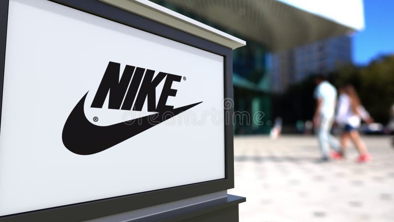 Street Signage Board with Nike Logo. Blurred Office Center, Walking People Background. Editorial Editorial Stock Image - Illustration emblem, international: 80325979