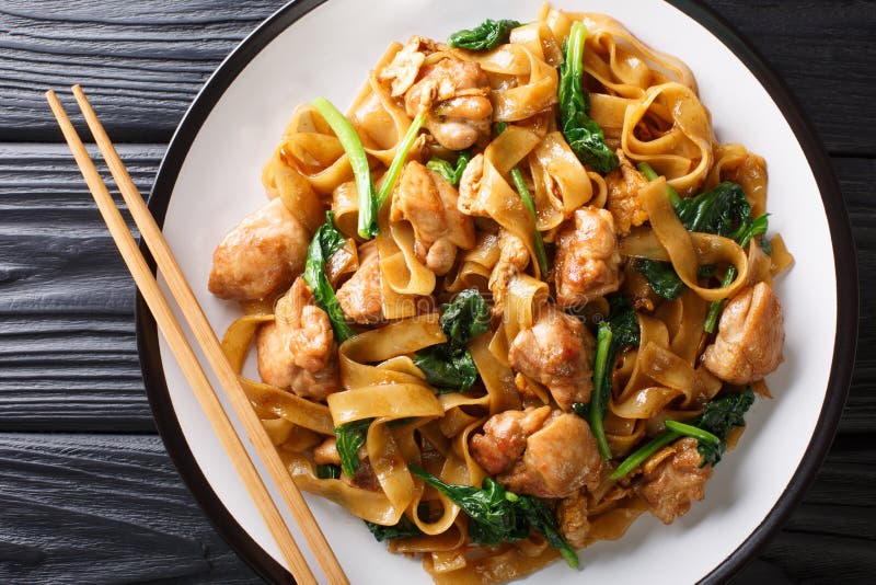 Street Thai food noodles with chicken, Chinese broccoli and egg close-up on a plate. Horizontal top view royalty free stock photos Street Thai food noodles with chicken, Chinese broccoli and egg close-up on a plate. Horizontal top view royalty free stock photos