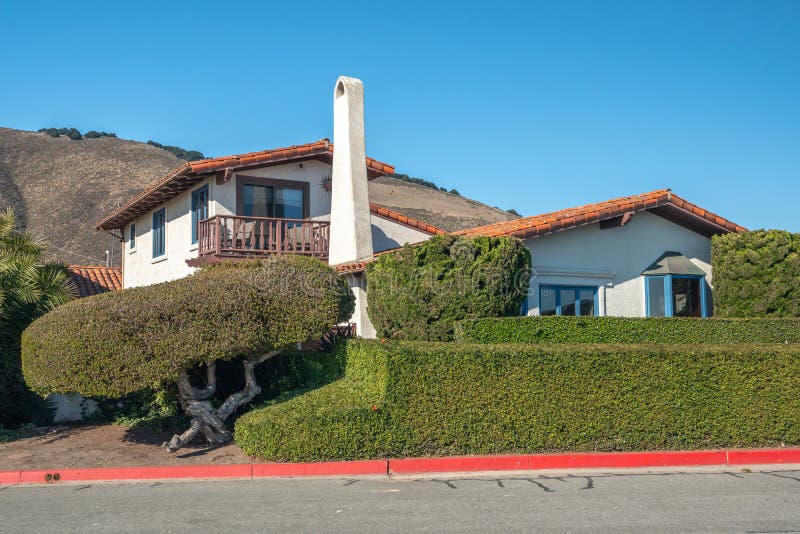 Beautiful house with nicely landscaped front the yard and mountains on background in small beach town in California. Beautiful house with nicely landscaped front the yard and mountains on background in small beach town in California