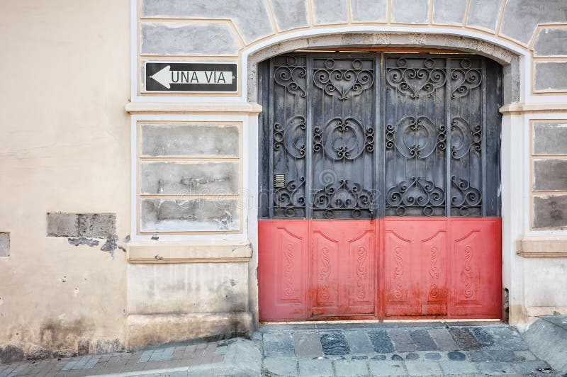 Street view of an old building facade with metal gate, architecture background, Latacunga, Ecuador royalty free stock images