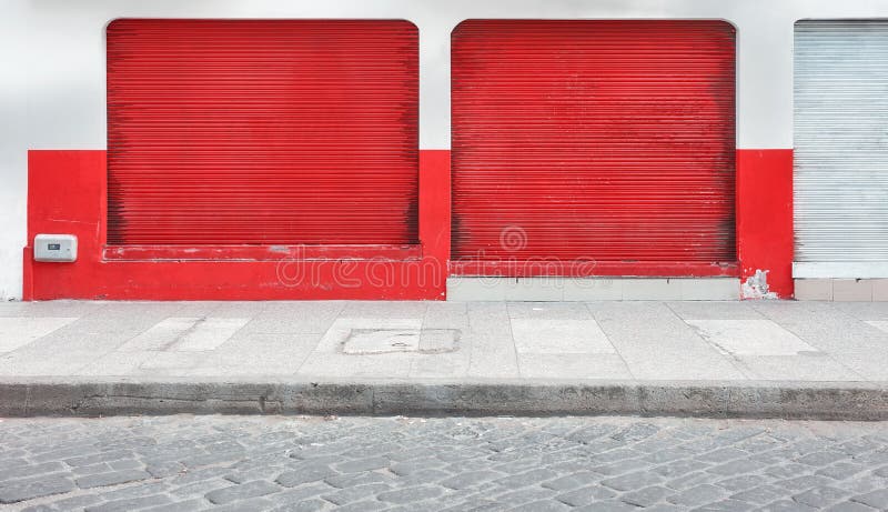 Street view of a shop with closed rolling shutters stock photography