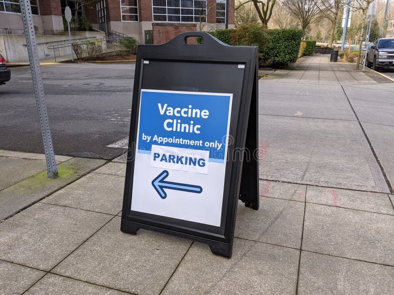 Street view of a sign pointing out the way to a Vaccine Clinic in King County, WA