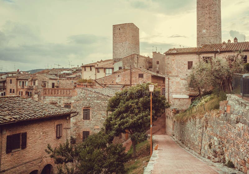 Streets and gardens of Italian medieval town with roofs of mansions at evening landscape of Tuscany. stock photography Streets and gardens of Italian medieval town with roofs of mansions at evening landscape of Tuscany. stock photography