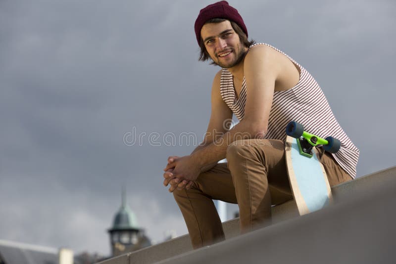 Streetwise skateboarder. Urban lifestyle portrait of a streetwise skateboarder, sitting on concrete steps royalty free stock photography Streetwise skateboarder. Urban lifestyle portrait of a streetwise skateboarder, sitting on concrete steps royalty free stock photography