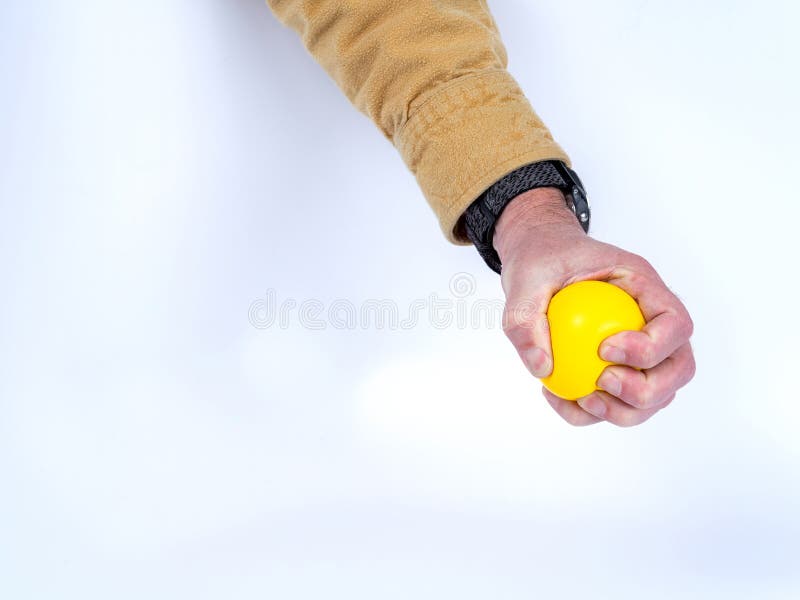 Stress Relief with a Yellow Rubber Ball Stock Photo Image of fingers