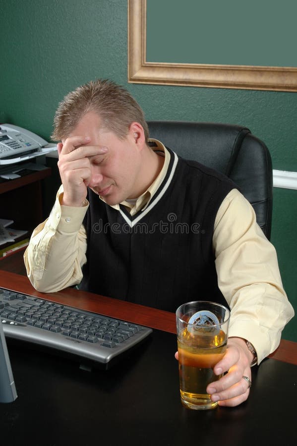 Stressed. Man is stressed over life and has a drink in his hands