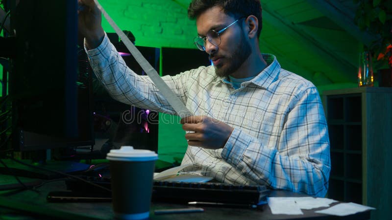 Stressed annoyed Indian Arabian man checking information bills code male looking at computer monitor trader guy stock images
