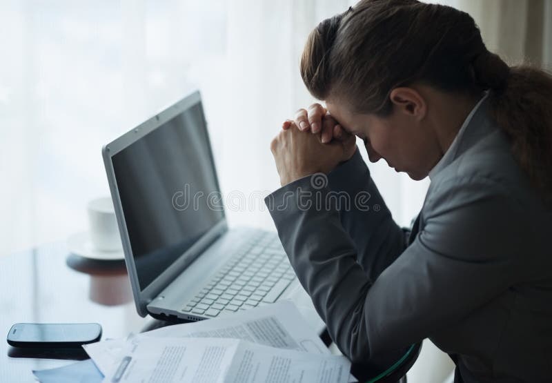 Stressed business woman working sitting at desk stock photography