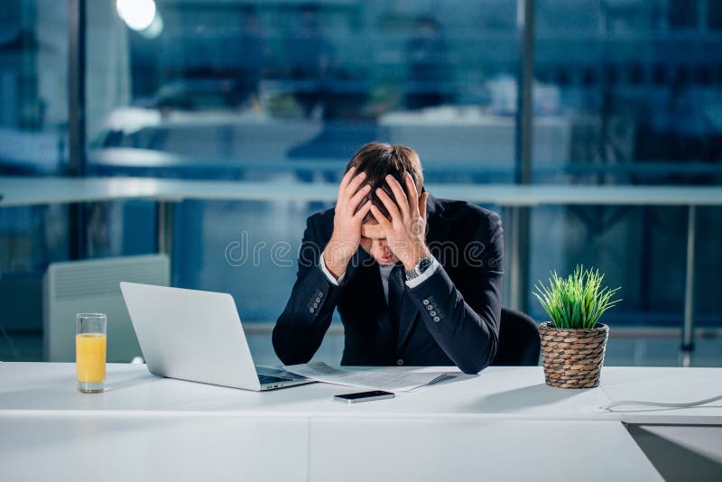Stressed businessman having problems and headache at work royalty free stock image Stressed businessman having problems and headache at work royalty free stock image