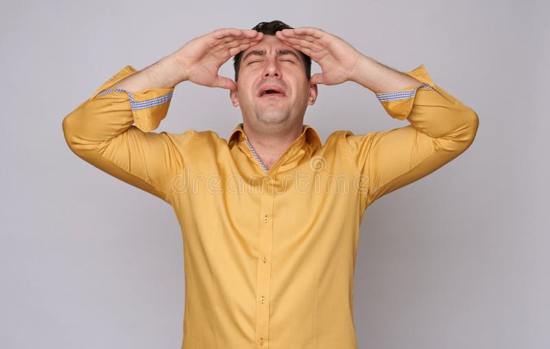 Stressed businessman isolated on grey