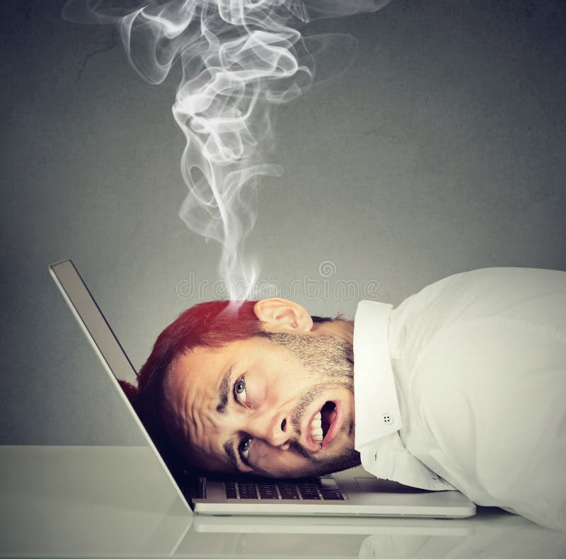 Stressed employee man with overheated brain using laptop stock photos Stressed employee man with overheated brain using laptop stock photos
