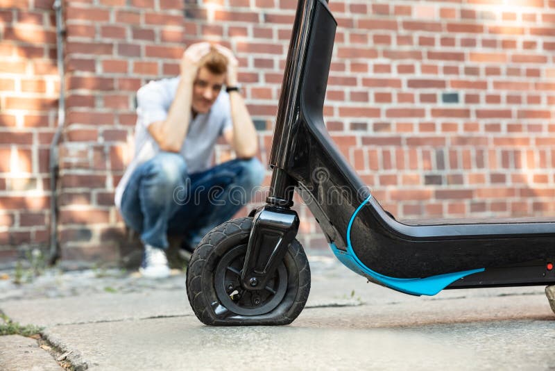 Stressed Man Looking at Flat Tire on EScooter Stock Photo Image of outdoors, flat 181835958