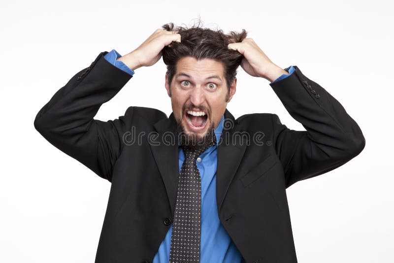 Stressed out businessman pulling his hair and screaming