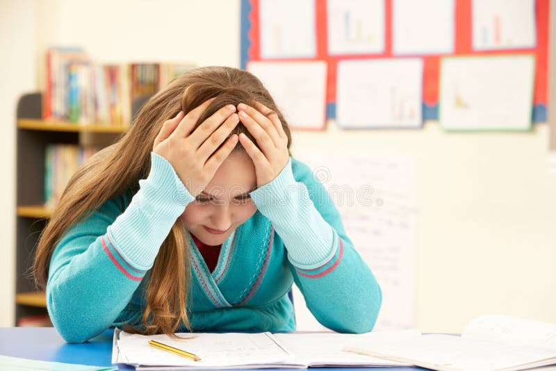 Stressed Schoolgirl Studying In Classroom Fed Up