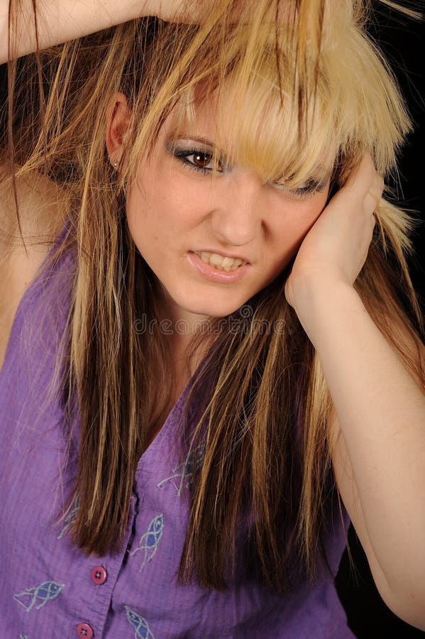 Stressed woman pulling hair stock image