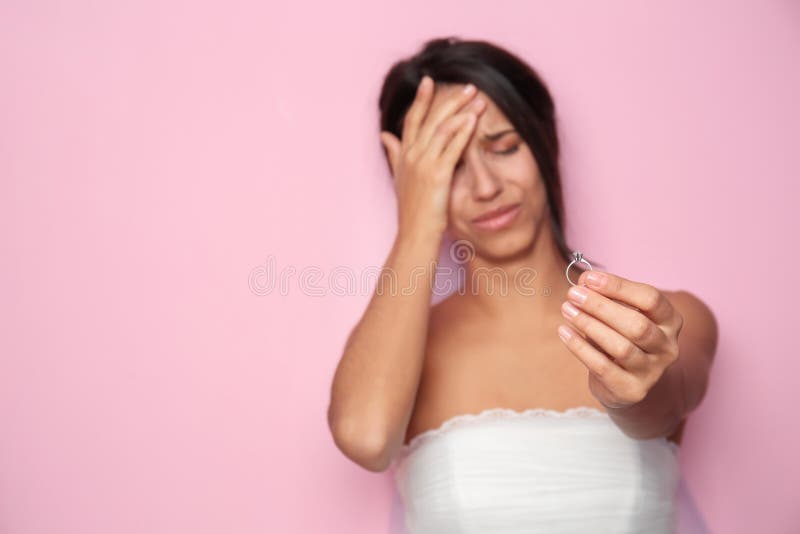 Stressed young bride with wedding ring on color background royalty free stock photos Stressed young bride with wedding ring on color background royalty free stock photos
