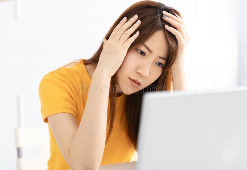 Stressed young using laptop at home stock images
