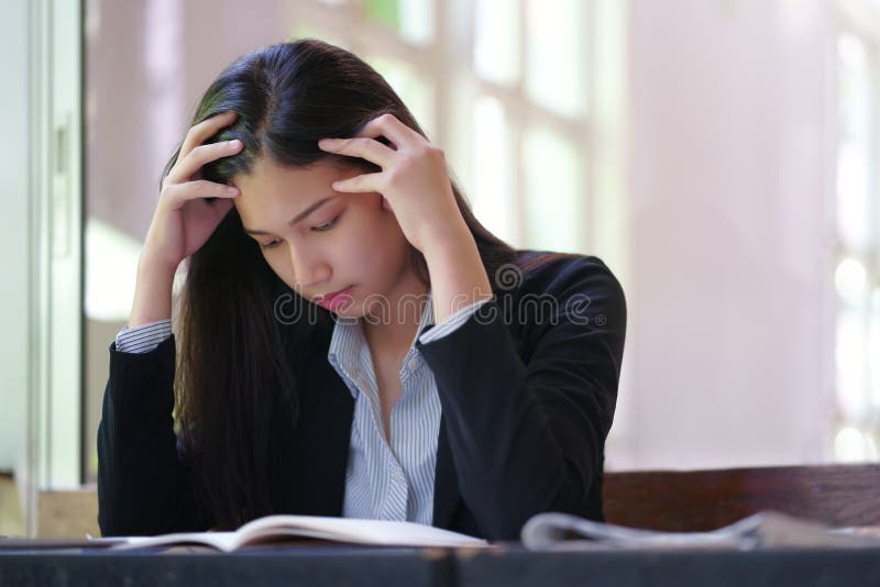 Stressed young woman doing paperwork planning difficult for work stock photography Stressed young woman doing paperwork planning difficult for work stock photography