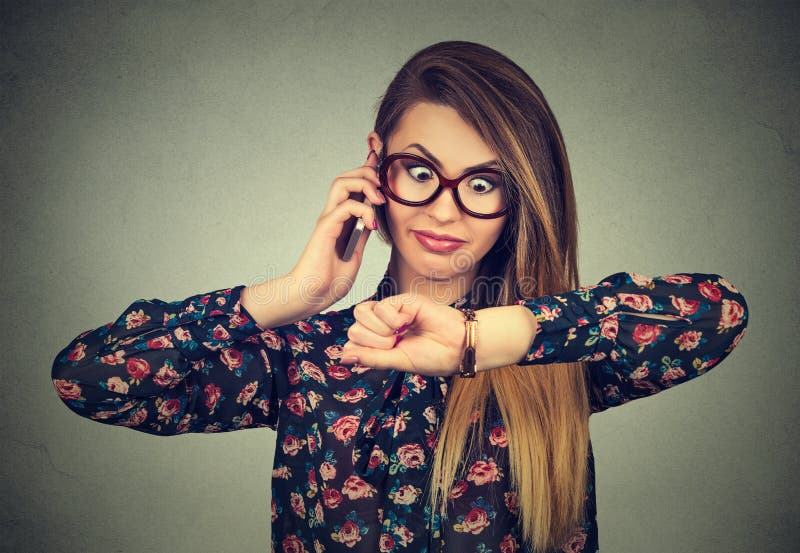 Business and time management concept. Stressed surprised business woman looking at wrist watch, running late forgot about meeting. Business and time management concept. Stressed surprised business woman looking at wrist watch, running late forgot about meeting