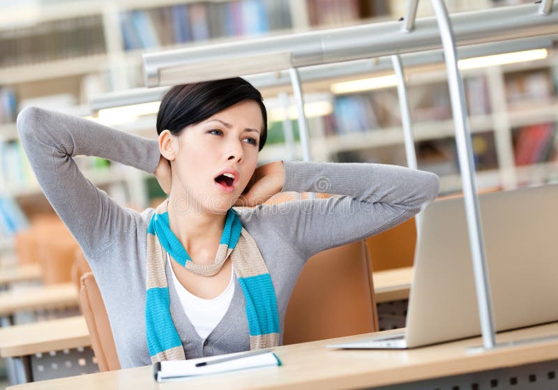 Stretching woman working on the silver laptop royalty free stock photography