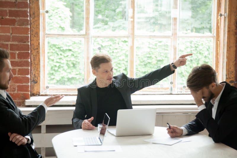 Strict boss telling upset employee to leave room during briefing