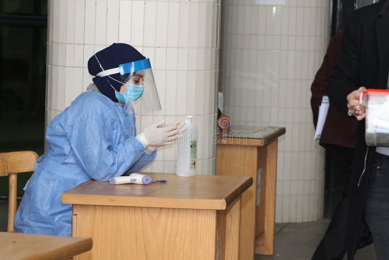 Strict precautionary measures before a building entry, temperature screening, face masks, hand gels royalty free stock photos