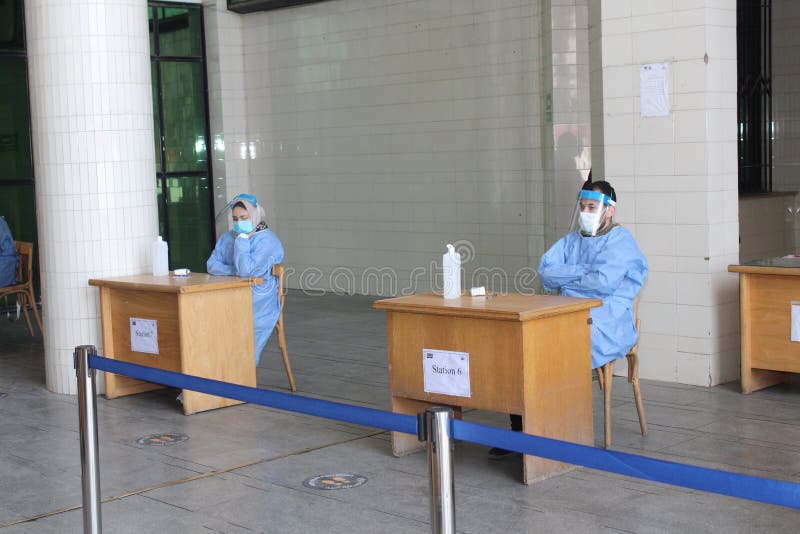 Strict precautionary measures before a building entry, temperature screening, face masks, hand gels stock photos