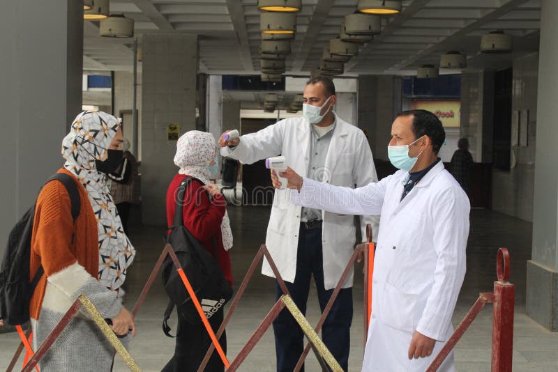 Strict precautionary measures before a building entry, temperature screening, face masks, hand gels royalty free stock photos