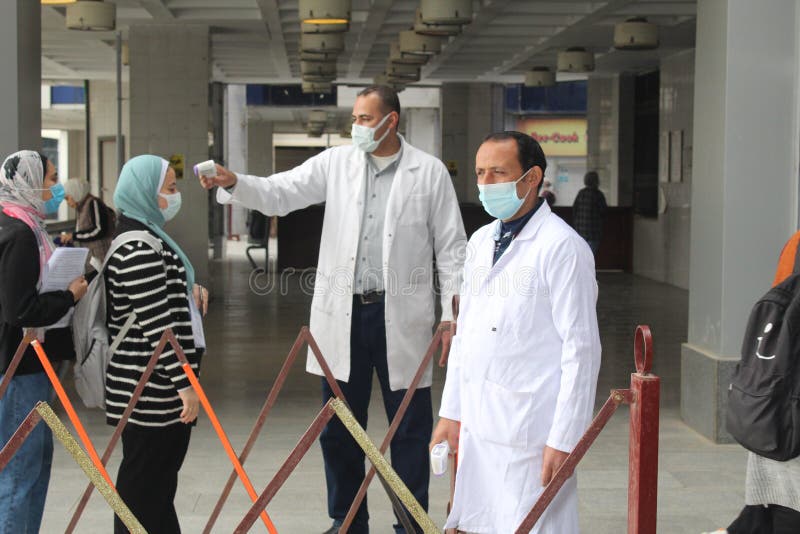 Strict precautionary measures before a building entry, temperature screening, face masks, hand gels royalty free stock image