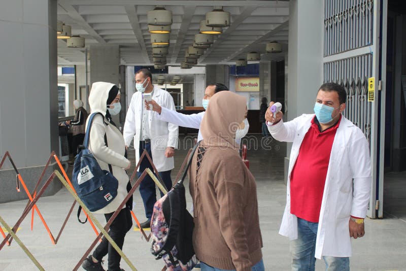 Strict precautionary measures before a building entry, temperature screening, face masks, hand gels stock images