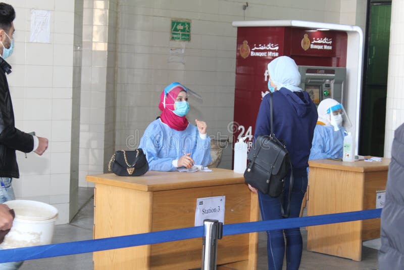 Strict precautionary measures before a building entry, temperature screening, face masks, hand gels stock photos